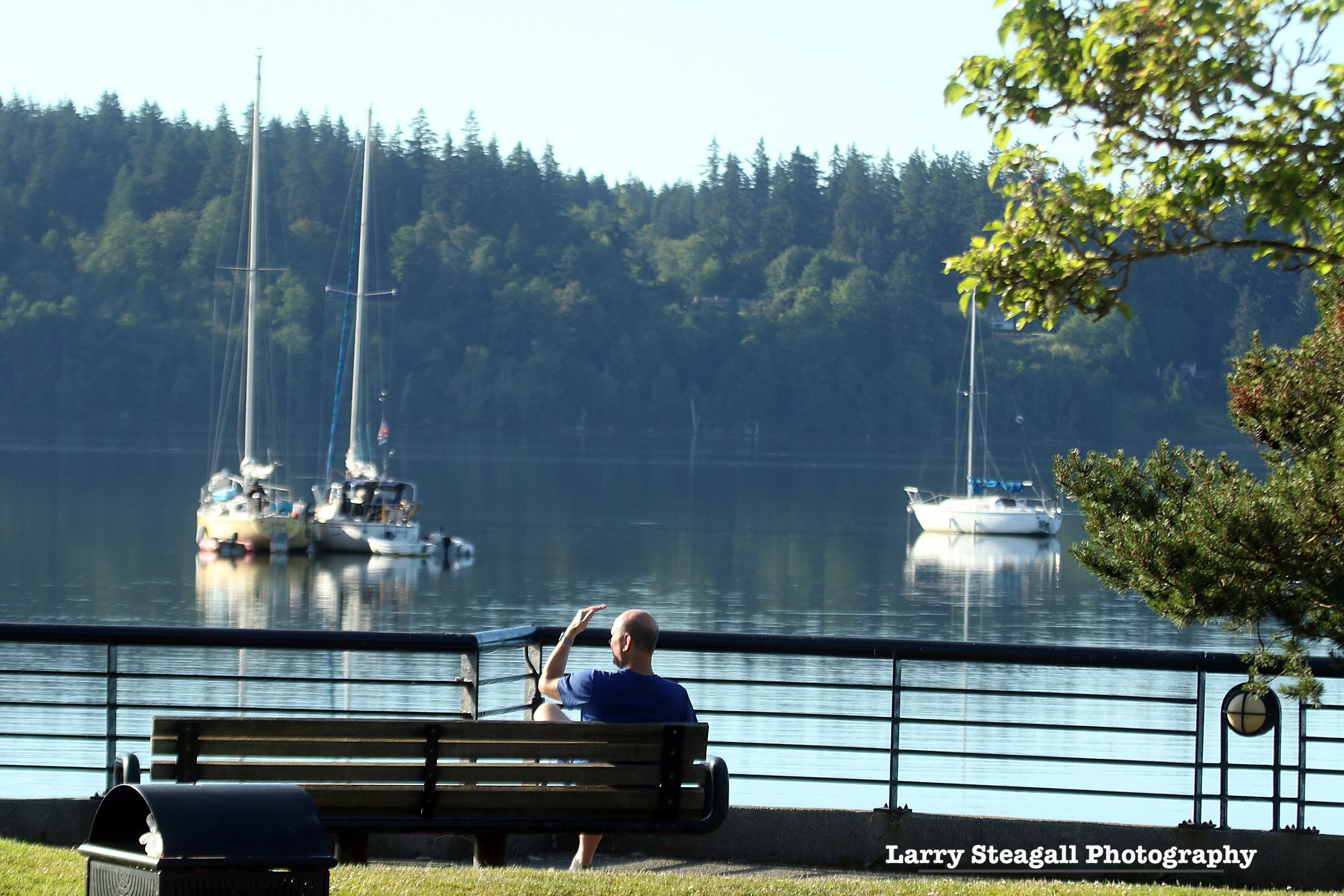 man relaxing on park bench